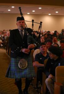 Mr. Dalton plays the bagpipes during All School Meeting
